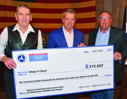 Representatives of the Village of Stuart accept check from Gov. Jim Pillen