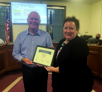 two people holding plaque