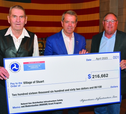 Representatives of the Village of Stuart accept check from Gov. Jim Pillen